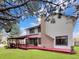 Exterior of the home featuring a covered back deck and green lawn at 8133 W Quarto Ave, Littleton, CO 80128