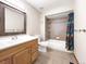 Bright bathroom featuring a shower-tub combo and vanity sink at 8133 W Quarto Ave, Littleton, CO 80128