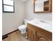 Functional half bathroom with classic vanity and neutral decor at 8133 W Quarto Ave, Littleton, CO 80128