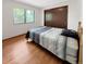 Cozy bedroom with hardwood floors, a window with natural light, and a double closet at 8133 W Quarto Ave, Littleton, CO 80128