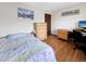 Cozy bedroom with hardwood floors, desk, and dresser at 8133 W Quarto Ave, Littleton, CO 80128