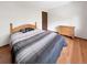 Bedroom with hardwood floors, simple wooden dresser, and neutral-toned walls at 8133 W Quarto Ave, Littleton, CO 80128