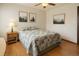 Cozy bedroom featuring warm wood floors, light walls, and decorative artwork at 8133 W Quarto Ave, Littleton, CO 80128
