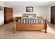Spacious bedroom featuring an oak sleigh bed, matching nightstands, and a large oak wardrobe at 8133 W Quarto Ave, Littleton, CO 80128