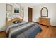Comfortable bedroom with hardwood floors, light walls, and decorative prints at 8133 W Quarto Ave, Littleton, CO 80128