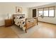 Cozy bedroom with a patterned comforter and a window with a small plant at 8133 W Quarto Ave, Littleton, CO 80128