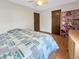 Bedroom with hardwood floors, ceiling fan, and a pink shelving unit at 8133 W Quarto Ave, Littleton, CO 80128