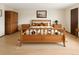 Comfortable bedroom with a patterned comforter, bedside tables, and neutral tones at 8133 W Quarto Ave, Littleton, CO 80128