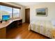 Bright bedroom with hardwood floors, a computer desk, and an exterior view at 8133 W Quarto Ave, Littleton, CO 80128