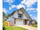 This well-kept home has white siding, brick accents, an attached garage, and a lush green lawn at 8133 W Quarto Ave, Littleton, CO 80128