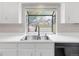 Bright kitchen sink and faucet with a view of the front yard at 8133 W Quarto Ave, Littleton, CO 80128