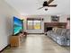 Living room with laminate floors, fireplace, and modern television at 8133 W Quarto Ave, Littleton, CO 80128