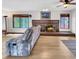 Spacious living room featuring a brick fireplace and laminate floors at 8133 W Quarto Ave, Littleton, CO 80128