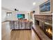 Comfortable living room featuring a brick fireplace and laminate floors at 8133 W Quarto Ave, Littleton, CO 80128