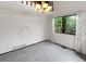 Open living area with a large window, neutral carpet, and ample natural light at 8133 W Quarto Ave, Littleton, CO 80128