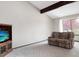Bright living room with vaulted ceilings, beam accents, and plush carpet at 8133 W Quarto Ave, Littleton, CO 80128