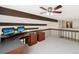 Cozy office loft with beam details and built-in desk/cabinet setup at 8133 W Quarto Ave, Littleton, CO 80128