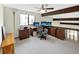 Bright office loft with ceiling fan, beam details, and built-in desk/cabinet setup at 8133 W Quarto Ave, Littleton, CO 80128