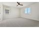 Bright and spacious bedroom featuring neutral carpet, white walls, and large windows at 42966 Colonial Trl, Elizabeth, CO 80107