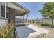 A view of the side and back porch with lush landscaping and a fenced in back yard at 26221 E 5Th Pl, Aurora, CO 80018