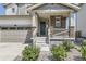 Inviting front porch with stone accents and a well-maintained entryway at 26221 E 5Th Pl, Aurora, CO 80018