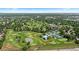 Scenic aerial view showcasing the neighborhood, golf course, community pool, and surrounding green spaces at 5955 Blue Sage Way, Littleton, CO 80123