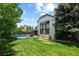 Manicured backyard with a large grassy lawn and an in-ground pool with a diving board at 5955 Blue Sage Way, Littleton, CO 80123