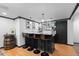 Basement bar featuring dark cabinetry, shelving, and seating at 5955 Blue Sage Way, Littleton, CO 80123