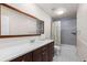 Bathroom featuring a modern vanity, large mirror, and tile flooring at 5955 Blue Sage Way, Littleton, CO 80123
