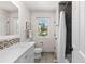 Bathroom featuring a large vanity, decorative mirror, and tile flooring at 5955 Blue Sage Way, Littleton, CO 80123