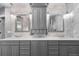 Modern bathroom featuring double sinks, gray cabinets, and stylish marble countertops at 5955 Blue Sage Way, Littleton, CO 80123