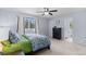 Bedroom featuring carpet, a queen-size bed, and a door leading to a bathroom at 5955 Blue Sage Way, Littleton, CO 80123