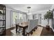Elegant dining room boasts a modern chandelier, gray chairs, and large windows at 5955 Blue Sage Way, Littleton, CO 80123