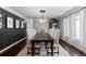 Formal dining room with modern lighting, paneled walls, and seating for eight at 5955 Blue Sage Way, Littleton, CO 80123