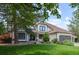 Charming two-story home boasts lush landscaping and a welcoming facade, creating instant curb appeal at 5955 Blue Sage Way, Littleton, CO 80123