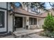 Home exterior with covered front porch, potted plants, and seating area at 5955 Blue Sage Way, Littleton, CO 80123
