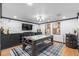 Spacious game room with hardwood floors, a stylish air hockey table, and a full entertainment center at 5955 Blue Sage Way, Littleton, CO 80123