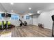 Bright home gym with wood look floors, exercise equipment, and large mirrors at 5955 Blue Sage Way, Littleton, CO 80123
