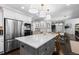 Modern kitchen features a large island with marble countertops and stainless steel appliances at 5955 Blue Sage Way, Littleton, CO 80123