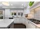 Bright, airy kitchen with white cabinets, marble countertops, and modern appliances at 5955 Blue Sage Way, Littleton, CO 80123