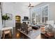 Bright living room with high ceilings, large windows, and white brick fireplace and shelving at 5955 Blue Sage Way, Littleton, CO 80123