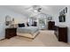 A bright and spacious primary bedroom with dark wood furniture and natural light at 5955 Blue Sage Way, Littleton, CO 80123