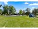 Picturesque park area featuring a playground and lush green grass under a bright blue sky at 5955 Blue Sage Way, Littleton, CO 80123