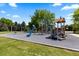 Community playground area with play structures, swings, and soft ground cover for safety at 5955 Blue Sage Way, Littleton, CO 80123
