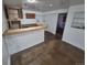 Basement bar area with overhead lighting, cabinets, and access to a separate room at 3136 S Cathay Cir, Aurora, CO 80013
