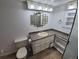 Bathroom featuring a vanity, multiple mirrors, and glass enclosed tiled shower at 3136 S Cathay Cir, Aurora, CO 80013
