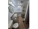 Bathroom featuring a vanity, sink, and shower with dark trim and a pebble floor at 3136 S Cathay Cir, Aurora, CO 80013