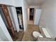 Modest bathroom with toilet, cabinet and access to mechanical closet at 3136 S Cathay Cir, Aurora, CO 80013