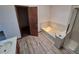 Bright bathroom featuring tile flooring, walk-in shower and separate tub at 3136 S Cathay Cir, Aurora, CO 80013