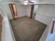 Bedroom with wall panelling, doors to adjoining rooms and carpeted flooring at 3136 S Cathay Cir, Aurora, CO 80013